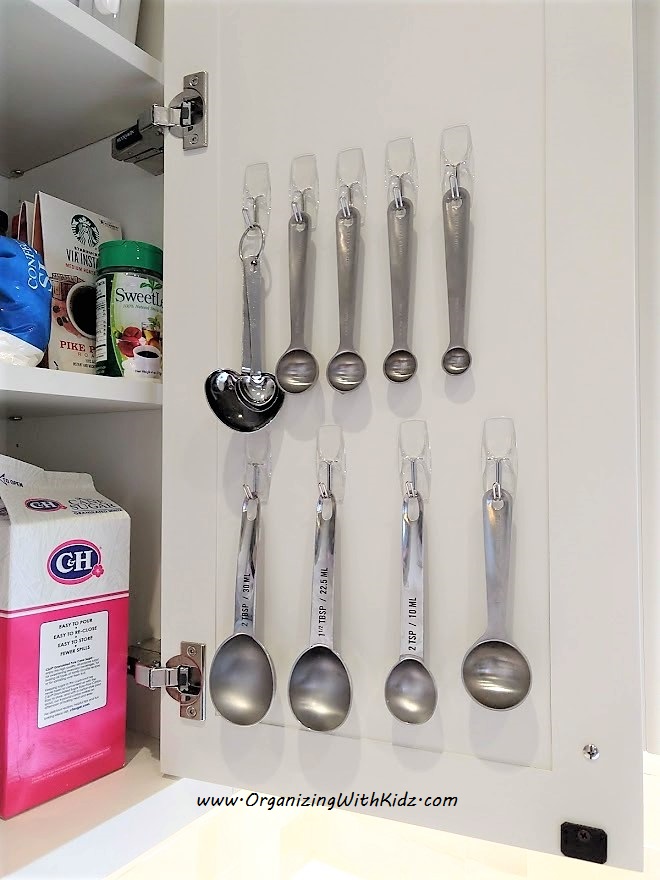 Command hooks help hang measuring spoons for easy access